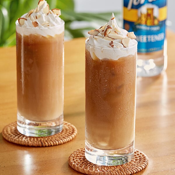 Two glasses of brown Torani Sugar-Free Sweetener drinks with whipped cream and almonds.