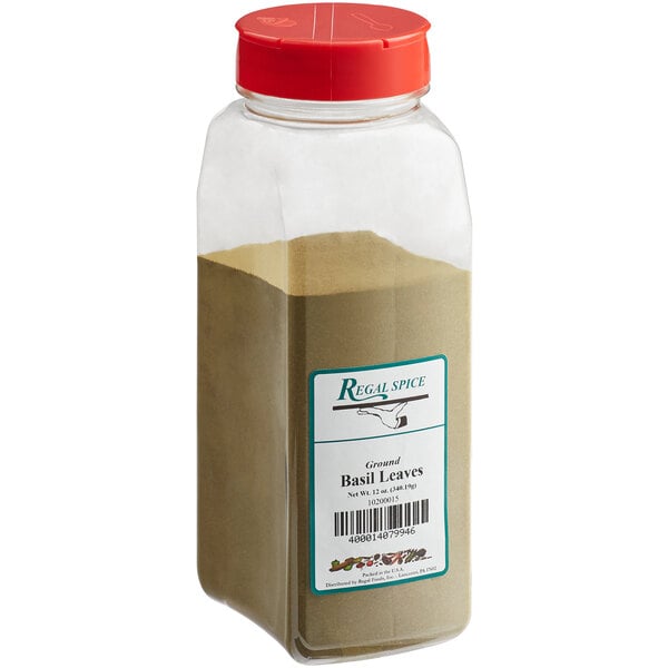 A clear container with a red lid and Regal Ground Basil Leaves, a brown powder.