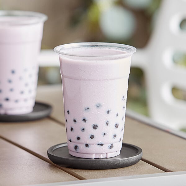 A glass and a plastic cup of Capora Taro Frappe.