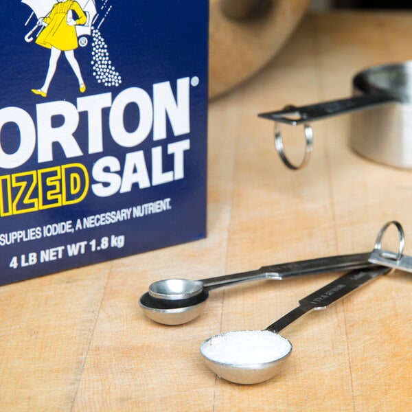 A box of Morton Iodized Table Salt next to a measuring spoon.