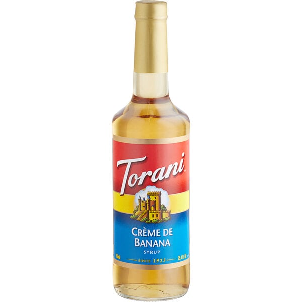 A Torani Creme de Banana 750 mL glass bottle of syrup with a label.