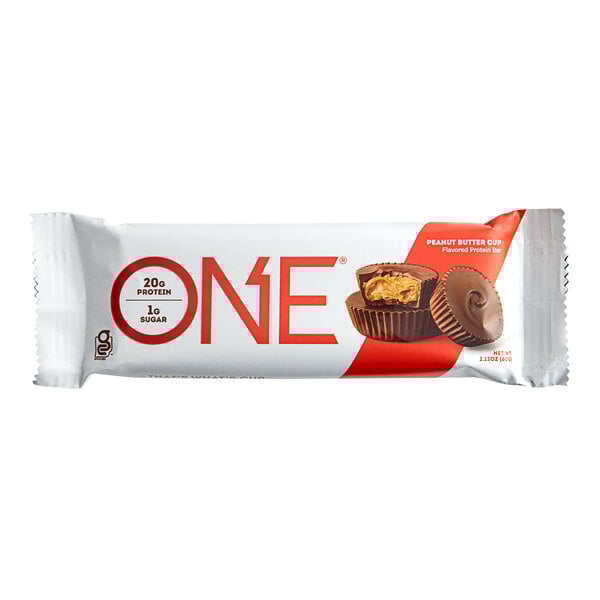 A ONE peanut butter cup protein bar with chocolate coating and a bite taken out of it.