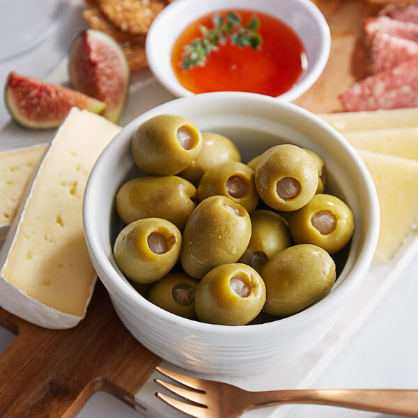 A white bowl filled with Belosa onion stuffed green olives.