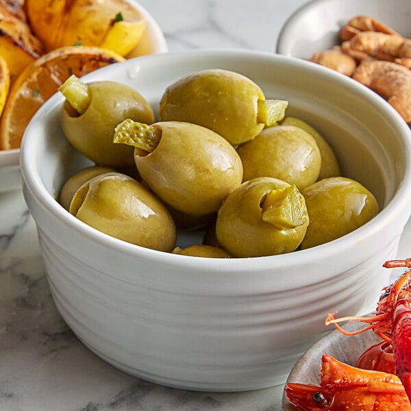 A bowl of Belosa green olives on a buffet counter.