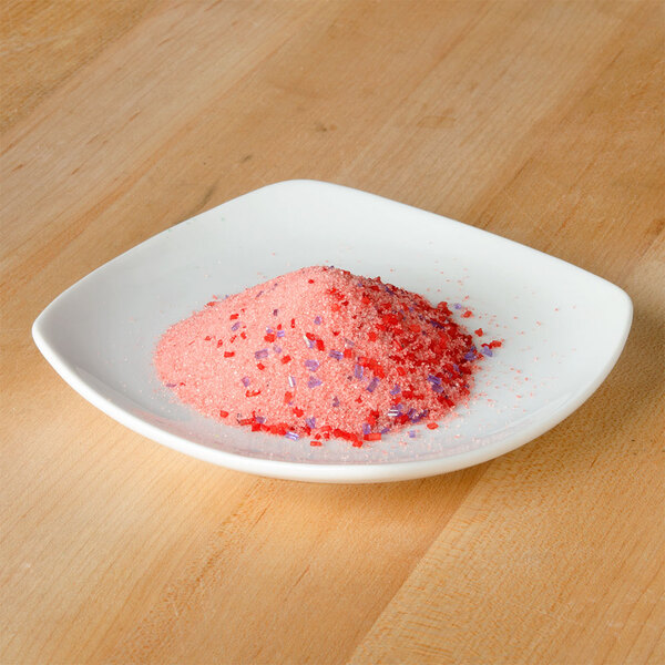 A white plate of pink and purple powder.