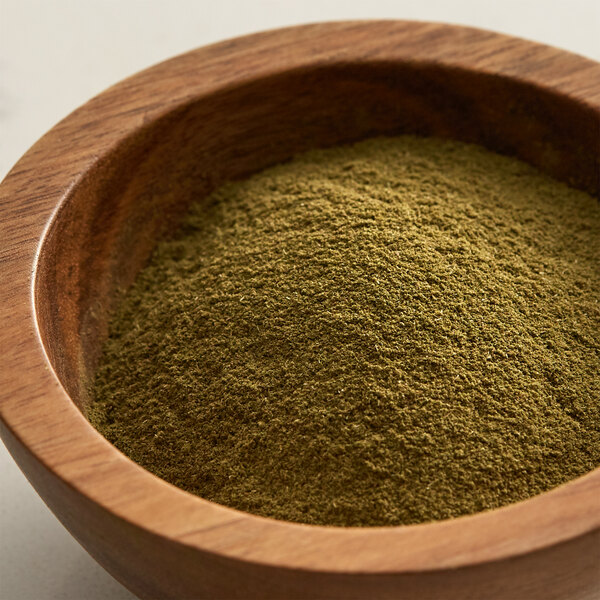 A bowl of Regal Ground Thyme powder on a table.