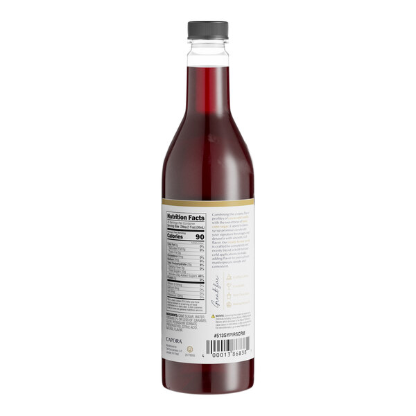 A close-up of a bottle of Capora Irish Cream flavoring syrup with a label.