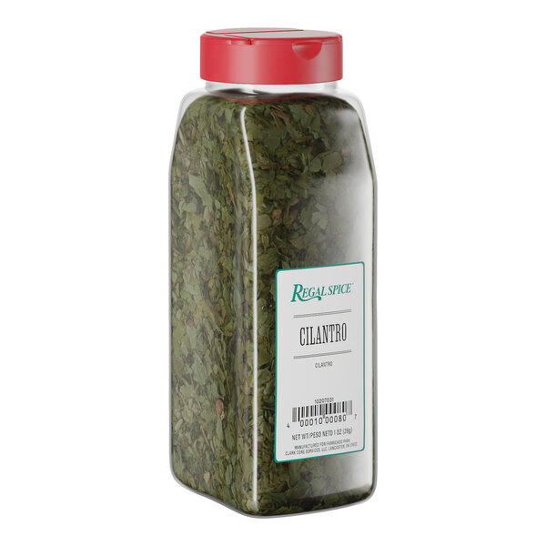 A plastic container of Regal Spice dried cilantro with a red lid.