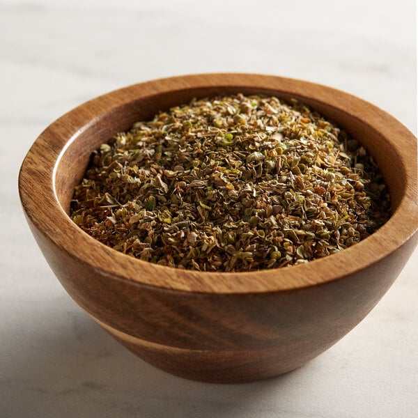 A wood bowl filled with Regal Fancy Oregano Leaves.