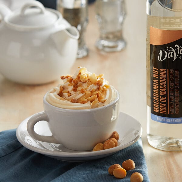 A cup of coffee with whipped cream and DaVinci Gourmet Sugar Free Macadamia Nut Flavoring Syrup.