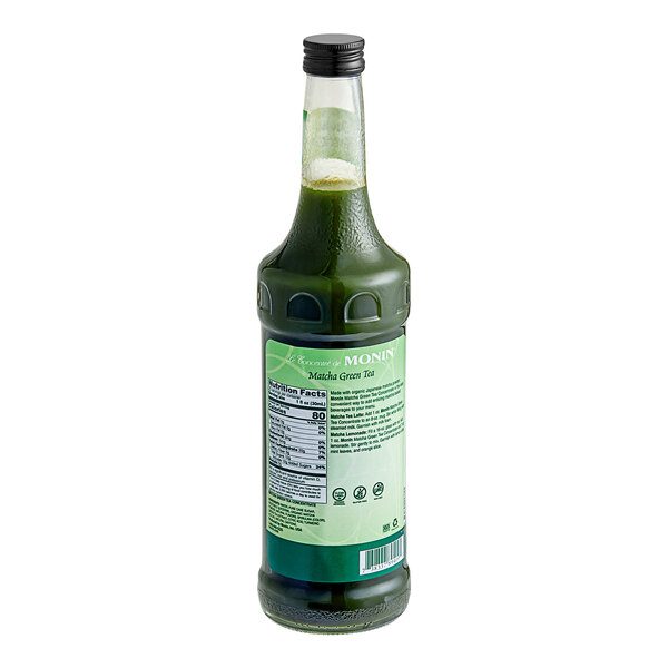 A green bottle of Monin Matcha Green Tea Concentrate.