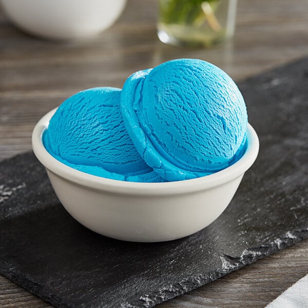 A bowl of I. Rice Blue Raspberry hard serve ice cream with a blue background.