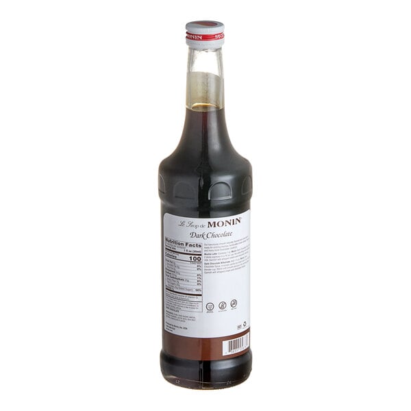 A bottle of Monin Premium Dark Chocolate syrup with a white label.