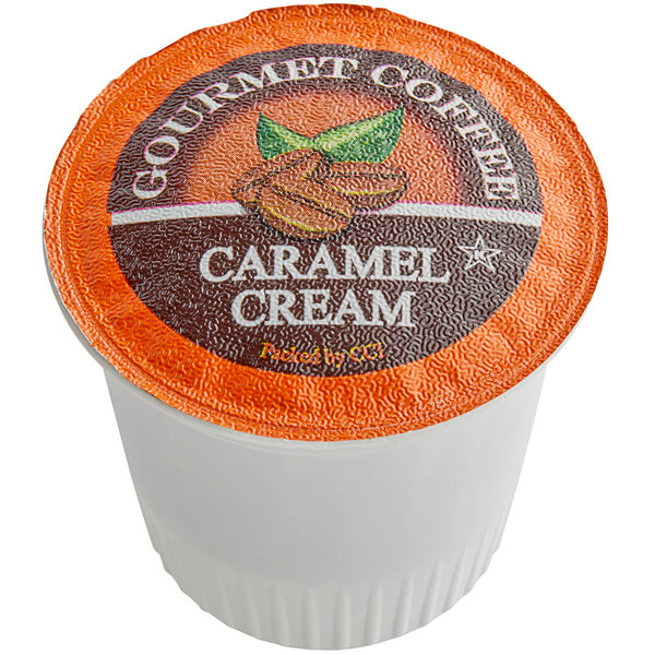 A white container of Caffe de Aroma Caramel Cream coffee single serve cups with a label.