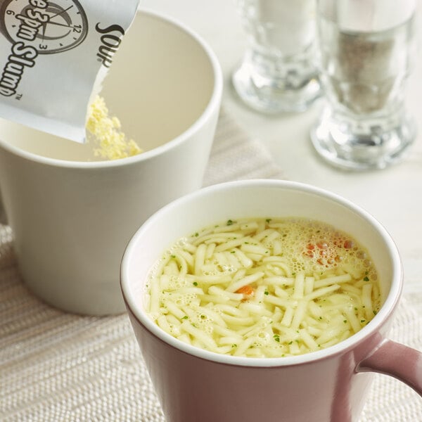 A white cup of Lipton instant chicken noodle soup with noodles in it.