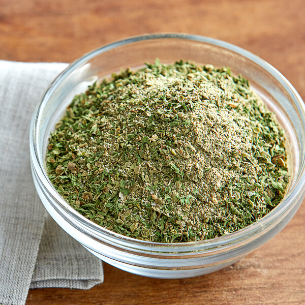 A white bowl of Regal Italian Seasoning on a table.