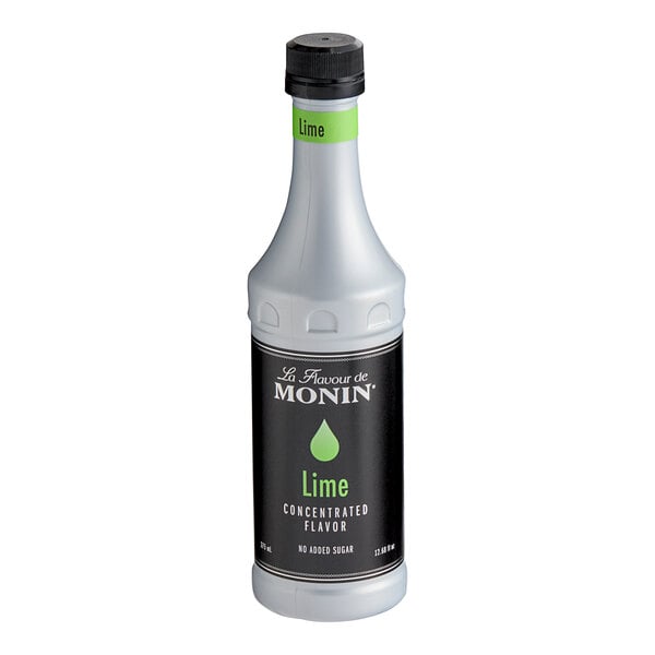 A white Monin bottle of lime concentrate with a black label.