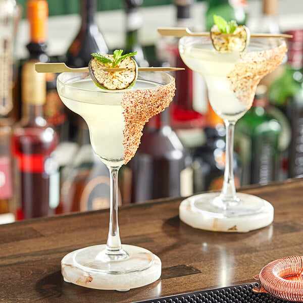 Two glasses of Q Mixers Margaritas on a bar counter.