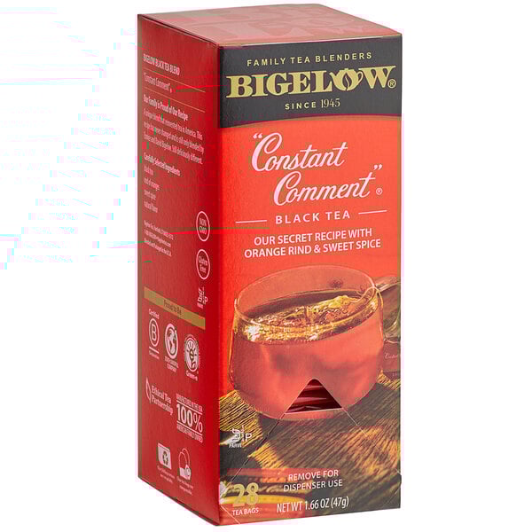A box of Bigelow Constant Comment tea bags on a counter with a cup of tea.