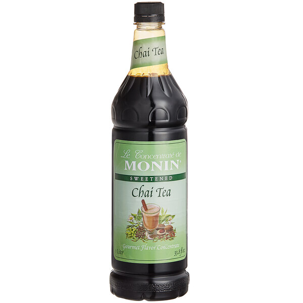 A close up of a Monin Chai Tea bottle with a green label.
