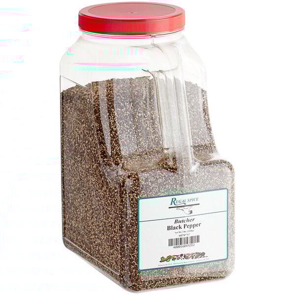 A plastic container of Regal Butcher Grind black pepper with a red lid.