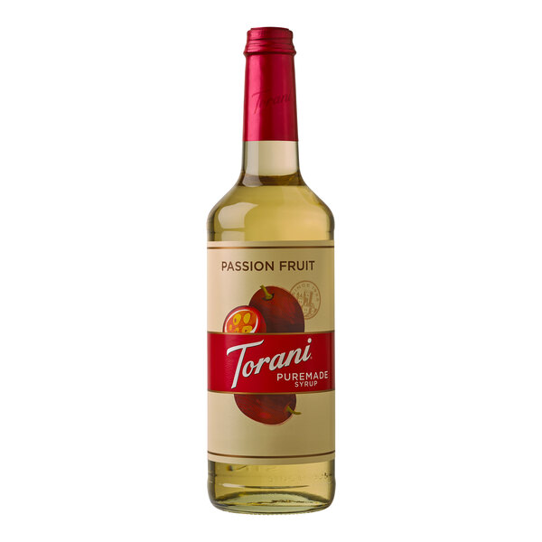 A close-up of a Torani Puremade Passion Fruit flavoring syrup bottle with a label.
