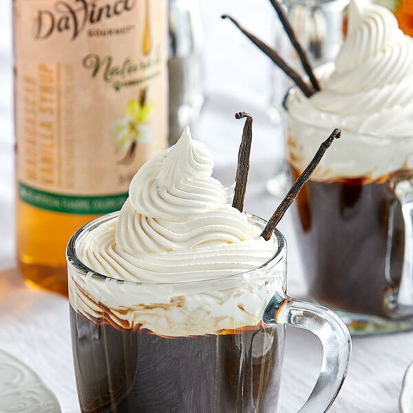 A glass mug of coffee with whipped cream and DaVinci Gourmet Madagascar Vanilla syrup.