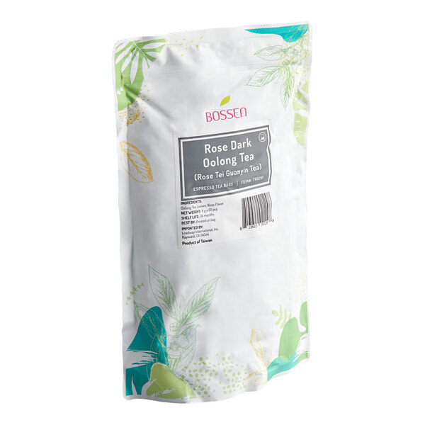 A white and green floral-patterned bag labeled 'Bossen Rose Dark Oolong Tea (Rose Tie Guanyin Tea)' with product information and a barcode on the front.