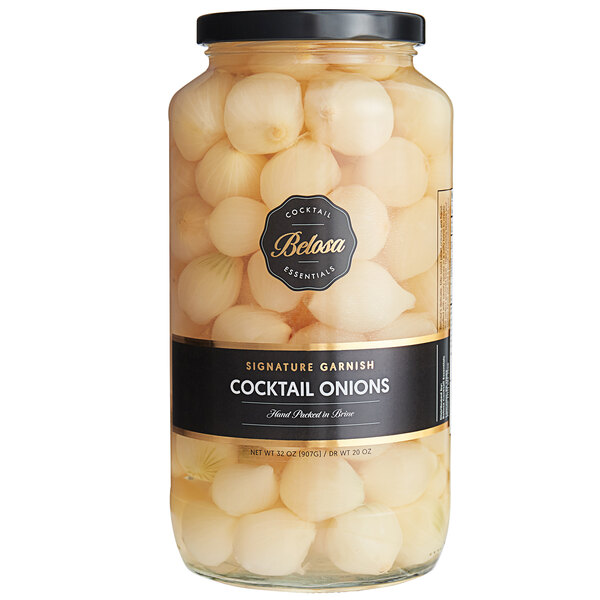 A jar of Belosa white pearl cocktail onions on a table with a black label.