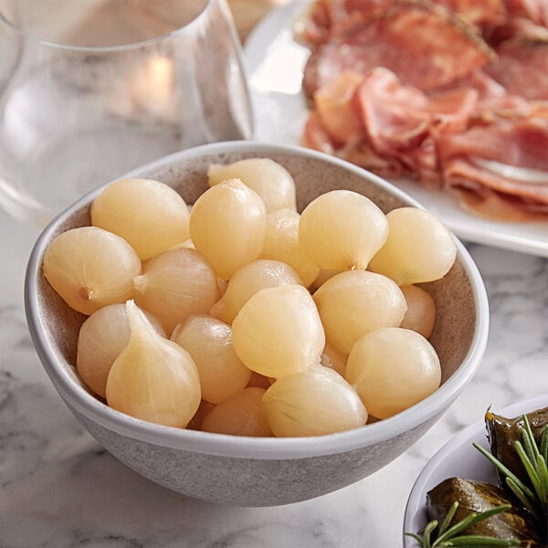 A bowl of Belosa white pearl cocktail onions on a counter.