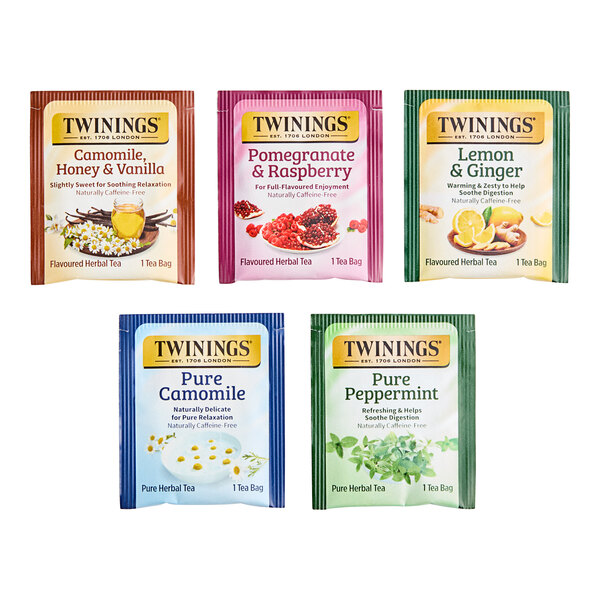 A group of Twinings assorted herbal tea bags with green, blue, purple, and green and white packages.