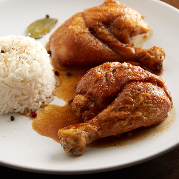 A plate of food with rice and Regal Adobo seasoned chicken.