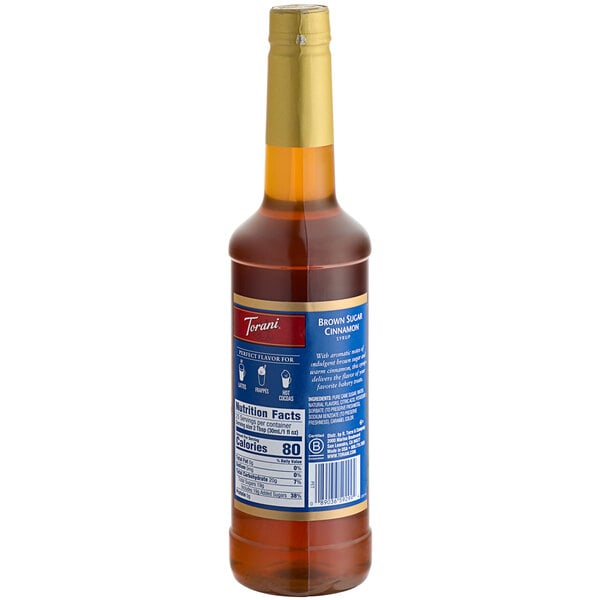 A Torani plastic bottle of brown sugar cinnamon syrup with a label.