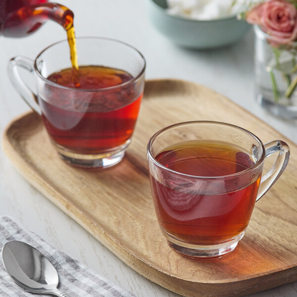 A couple of glass cups of Numi Organic Aged Earl Grey Loose Leaf Tea on a tray.