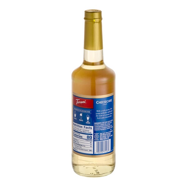A Torani Cheesecake flavoring syrup bottle with a blue label.