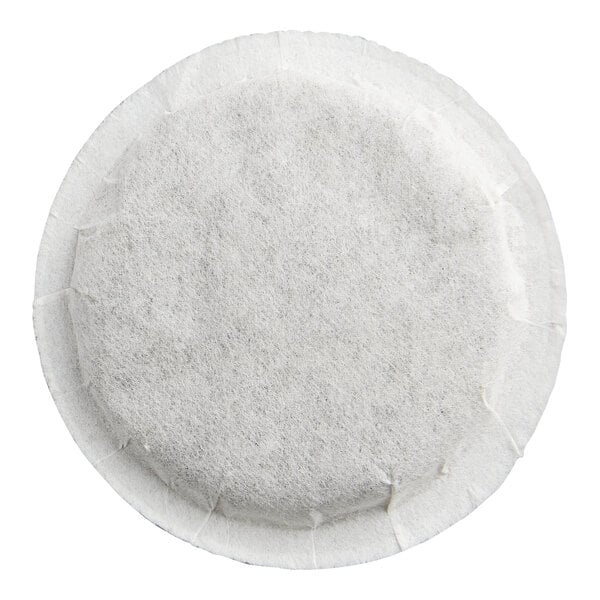 A round, white, flat tea pod made of a paper-like material.