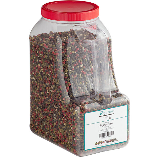 A plastic container of Regal Gourmet Peppercorn Medley with a red lid filled with peppercorns.