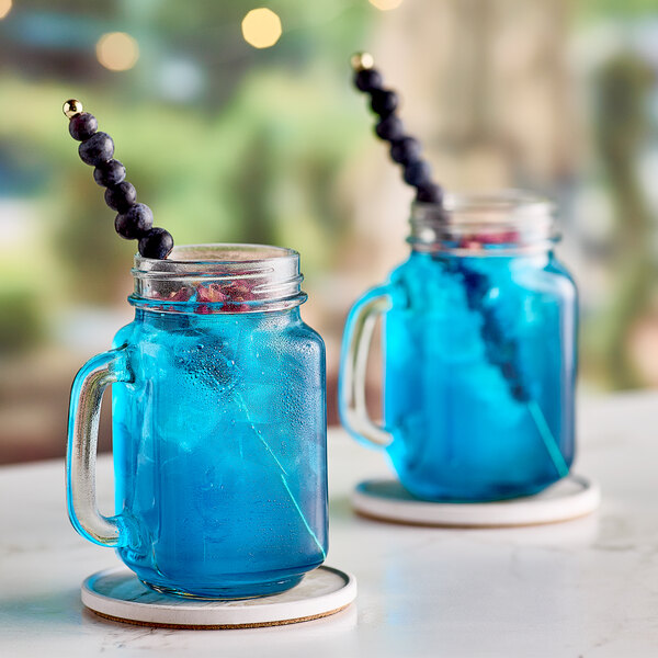 Two mason jars filled with blue Tiki Energy drinks.