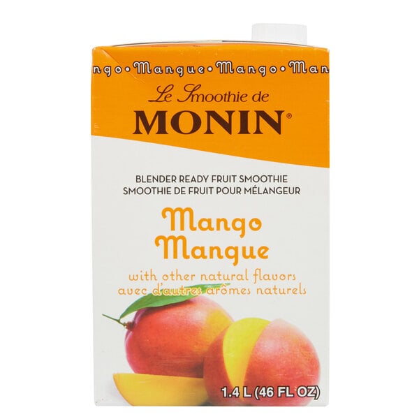 A case of Monin Mango Fruit Smoothie Mix on a table in a smoothie shop.