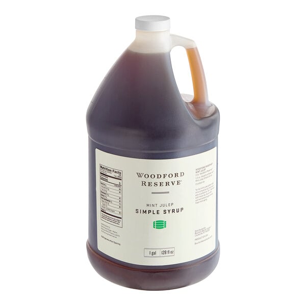 A jug of Woodford Reserve Mint Julep Simple Syrup with a white label and a handle.