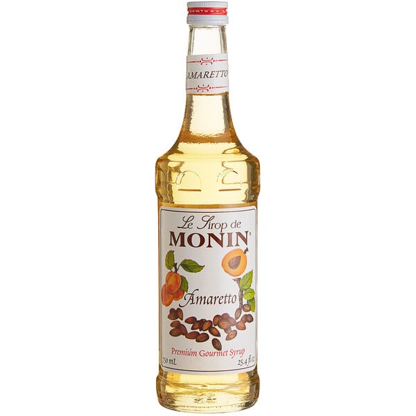 A bottle of Monin Premium Amaretto Flavoring Syrup with a label.