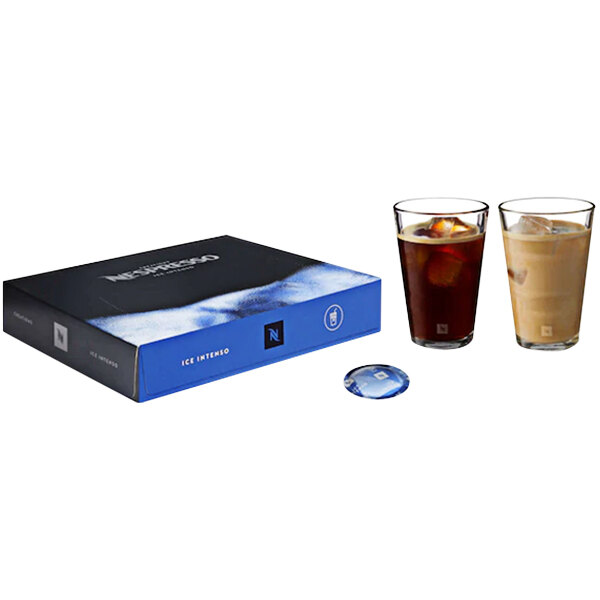 A glass of Nespresso Ice Intenso coffee with ice cubes next to a blue box of Nespresso Professional Ice Intenso coffee capsules.
