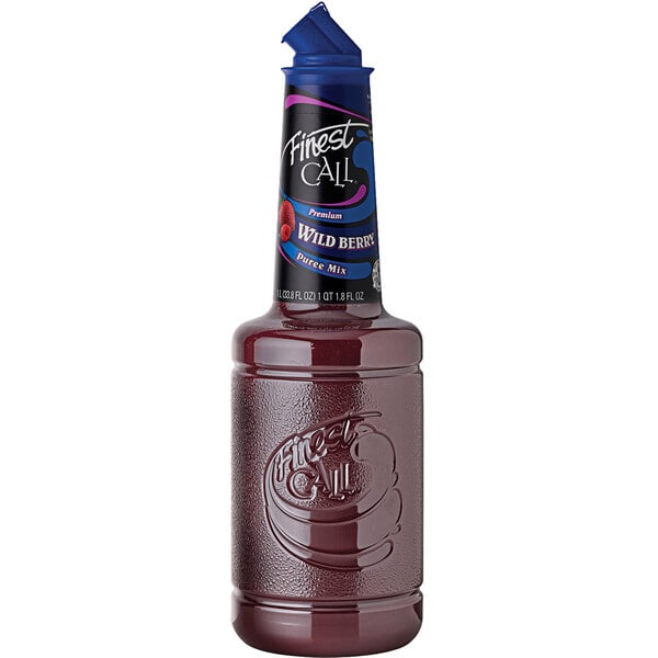 A close up of a Finest Call Wild Berry Puree Mix bottle with a blue cap.
