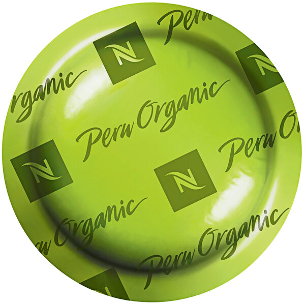 A green box with black text that says "Nespresso Professional Peru Organic Single Origin Coffee Capsules" on a counter.