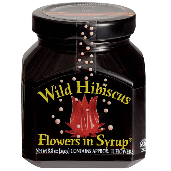 A jar of Wild Hibiscus flowers in syrup with a label.