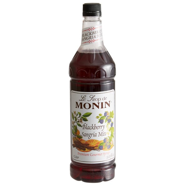 A close up of a Monin blackberry sangria mix bottle.