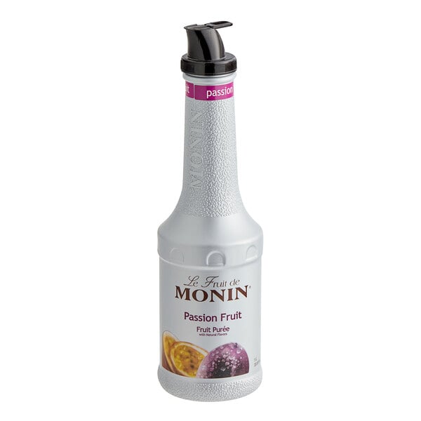 A close up of a white plastic bottle of Monin Passion Fruit Puree with a black lid.