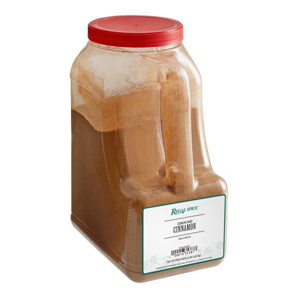 A white 4 lb. container of Regal ground cinnamon.