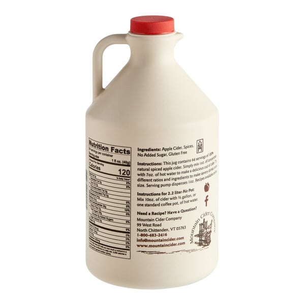 A large beige plastic jug with a red cap, featuring a handle and detailed product information, nutrition facts, and instructions printed on the side.