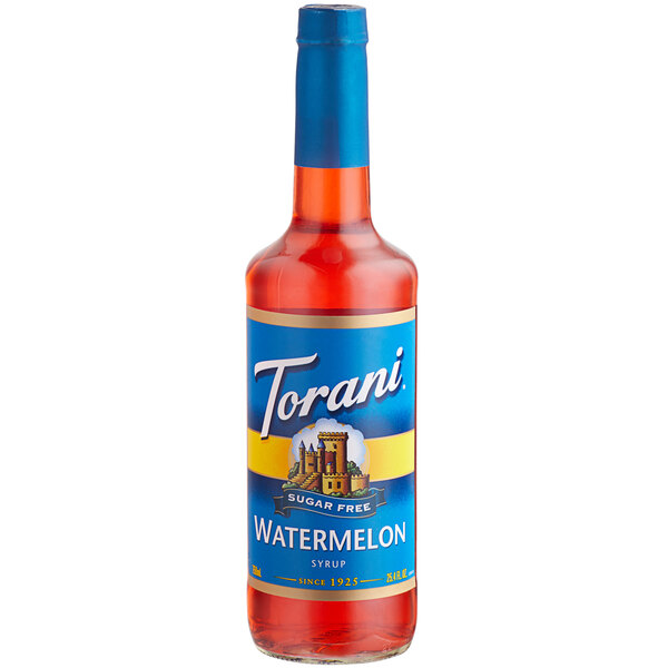 A close up of a Torani Sugar-Free watermelon syrup bottle on a table with a blue label.